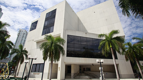 Miami Dade College Wolfson College Exterior which is a beige brutalist structure surrounded by palm trees